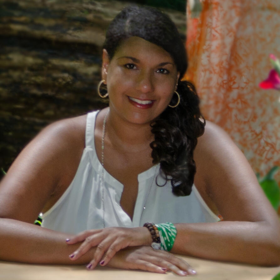 Cristina Cañizares professional woman siting at a desk hands on the table smiling
